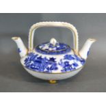 A 19th Century Worcester Double Spouted Teapot decorated in underglaze blue and with gilded feet