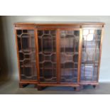 An Edwardian Mahogany Breakfront Dwarf Bookcase, the moulded top above a reeded frieze and four