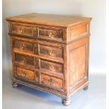 A 17th Century Oak Chest with four moulded drawers with brass drop handles and with bun feet, 100