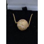 An 18ct gold and diamond set pendant in the form of a ball together with a linked chain, 10 grams