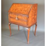 A 19th Century Dutch Marquetry bureau, the fall front enclosing a fitted inlaid interior above two