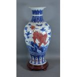 A Chinese porcelain oviform vase decorated with iron red and under glaze blue and six character mark