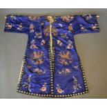 A Chinese silkwork Kimono ,decorated with butterflies amongst foliage on a blue ground