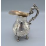 A Swedish white metal jug with engraved decoration and shaped handle,6.5oz, 16cms tall