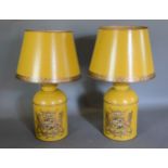 A pair of Toleware table lamps each with a gilded Armorial upon a mustard ground, 70cms tall