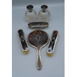 A George V silver, tortoiseshell and pique work dressing table set, comprising a pair of scent