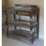 A Victorian Carved Oak Buffet with two frieze mask head drawers and turned supports, 106 cms wide,