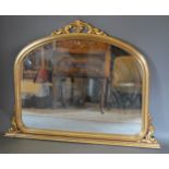 A French style gilded overmantle mirror of arched form, 97cms X 129cms