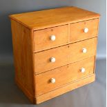 A Pine Chest Of Two Short And Two Long Drawers with ceramic handles raised upon a plinth, 90 cms