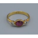 A 14ct gold ring set with a central cabachon ruby flanked by diamonds, 1.7grams, ring size K