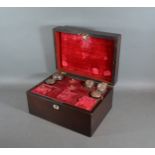 A 19th Century Rosewood dressing case, the hinged top enclosing a fitted interior with three