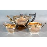 An Edwardian Silver Three Piece Tea Service comprising teapot, cream jug and two handled sucrier,