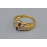 An 18ct gold ruby and diamond set ring with two Rubies flanked by diamonds, 3.1 grams, ring size K