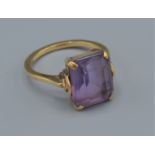 A 9ct gold dress ring set with a large rectangular Amethyst, 3.6grams, ring size L