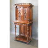 A 19th Century Continental Cabinet On Stand, the spindle galleried top above two carved doors