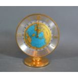 An Imhof Hours Of The World Time Clock, the circular dial within a brass case, 12cms tall