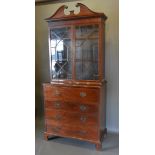 A Regency mahogany secretaire bookcase, the moulded cornice above two astragal glazed doors