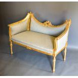 A French Gilded Salon Sofa, the shaped back with torch and quiver with scroll arms raised upon