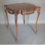 An Edwardian mahogany centre table, the shaped top above a shaped carved freize and raised upon