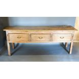 A 19th Century Dresser Base, the moulded top above three drawers with brass handles flanked by
