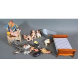 Four miniature porcelain dolls together with various dolls house furniture