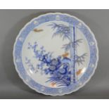 A Japanese porcelain charger decorated in under glaze blue and highlighted with gilt, 41cms diameter