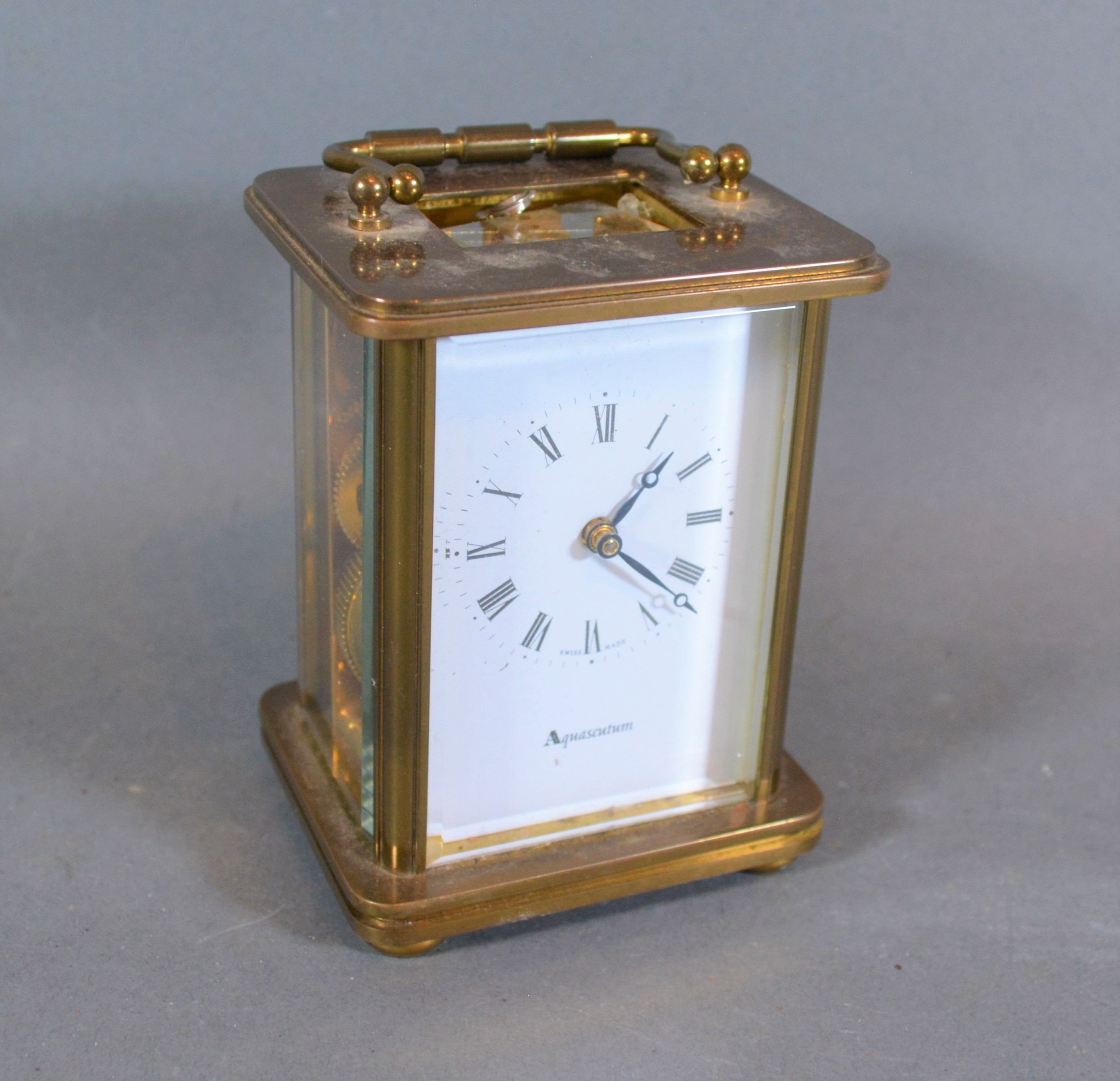 A brass cased carriage clock with lever escapement and carrying handle