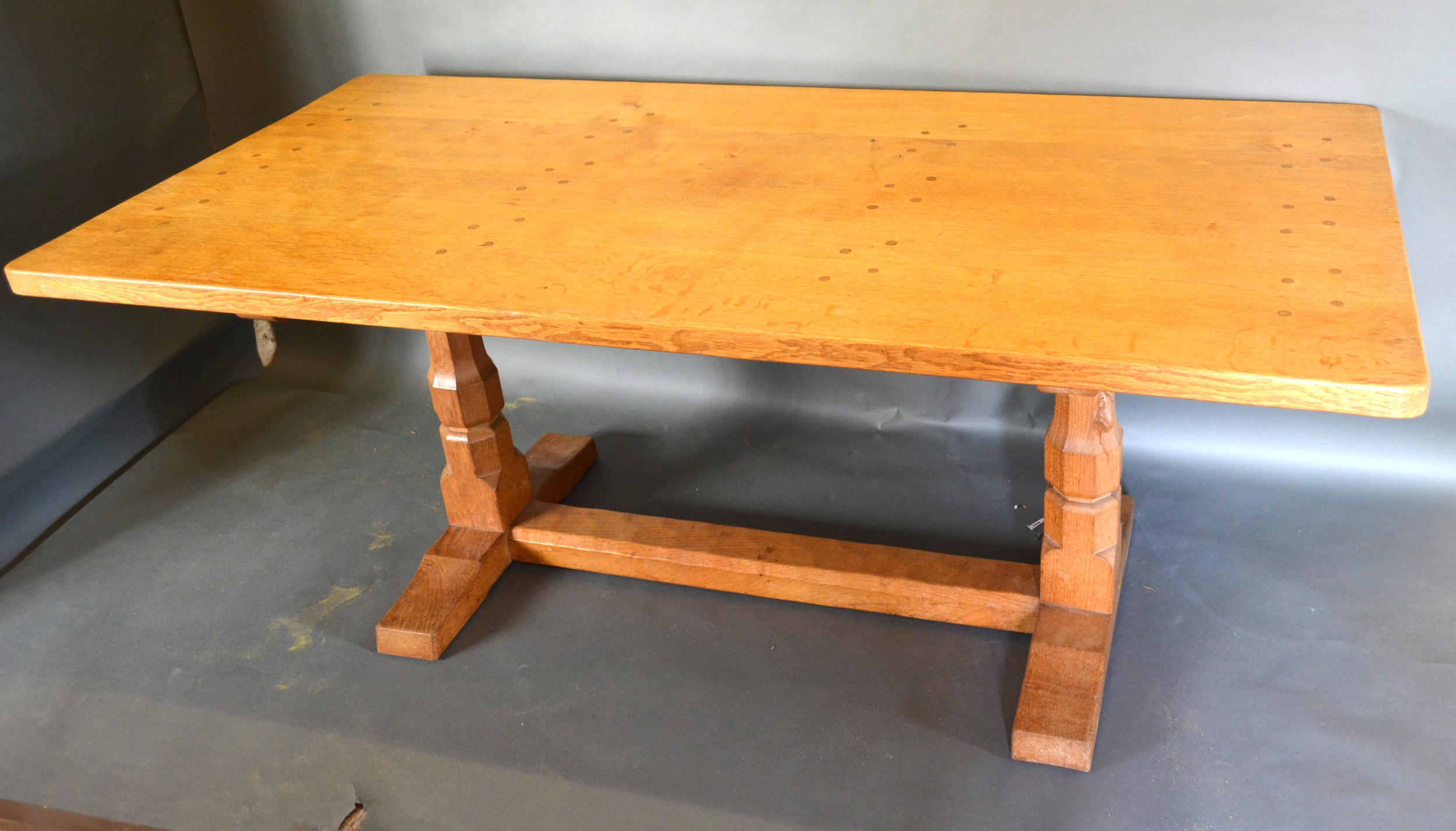 Robert (Mouseman) Thompson, An Oak Refectory Dining Table, the adze carved top above twin end