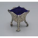 An Edwardian silver pin cushion in the form of a jardiniere, with scroll feet, London 1901, 7cms