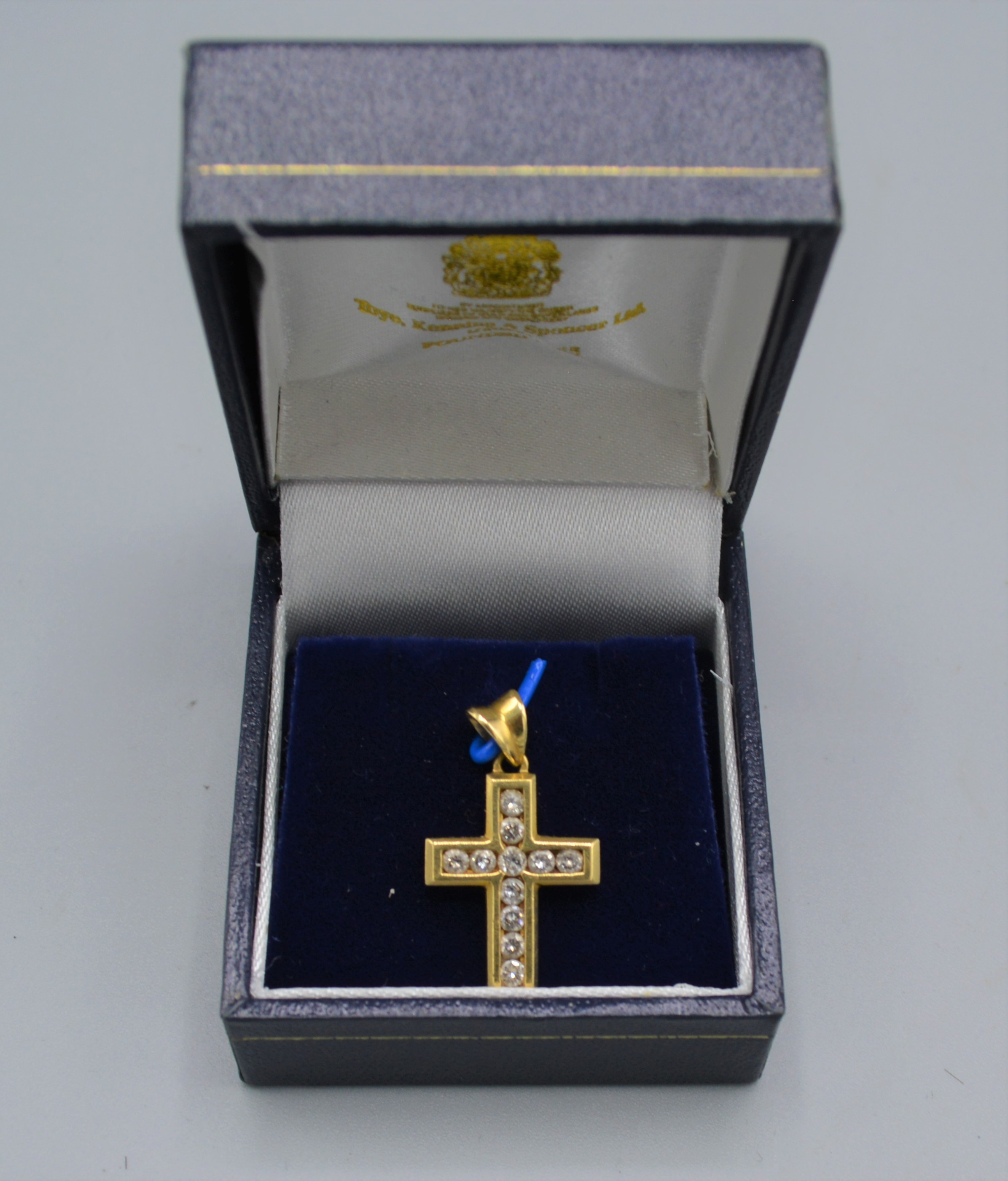 An 18ct gold diamond set crucifix pendant, 4.3 grams, 2cms long