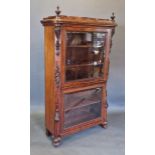 A 19th Century French mahogany display cabinet, the shaped top with turned finials above two