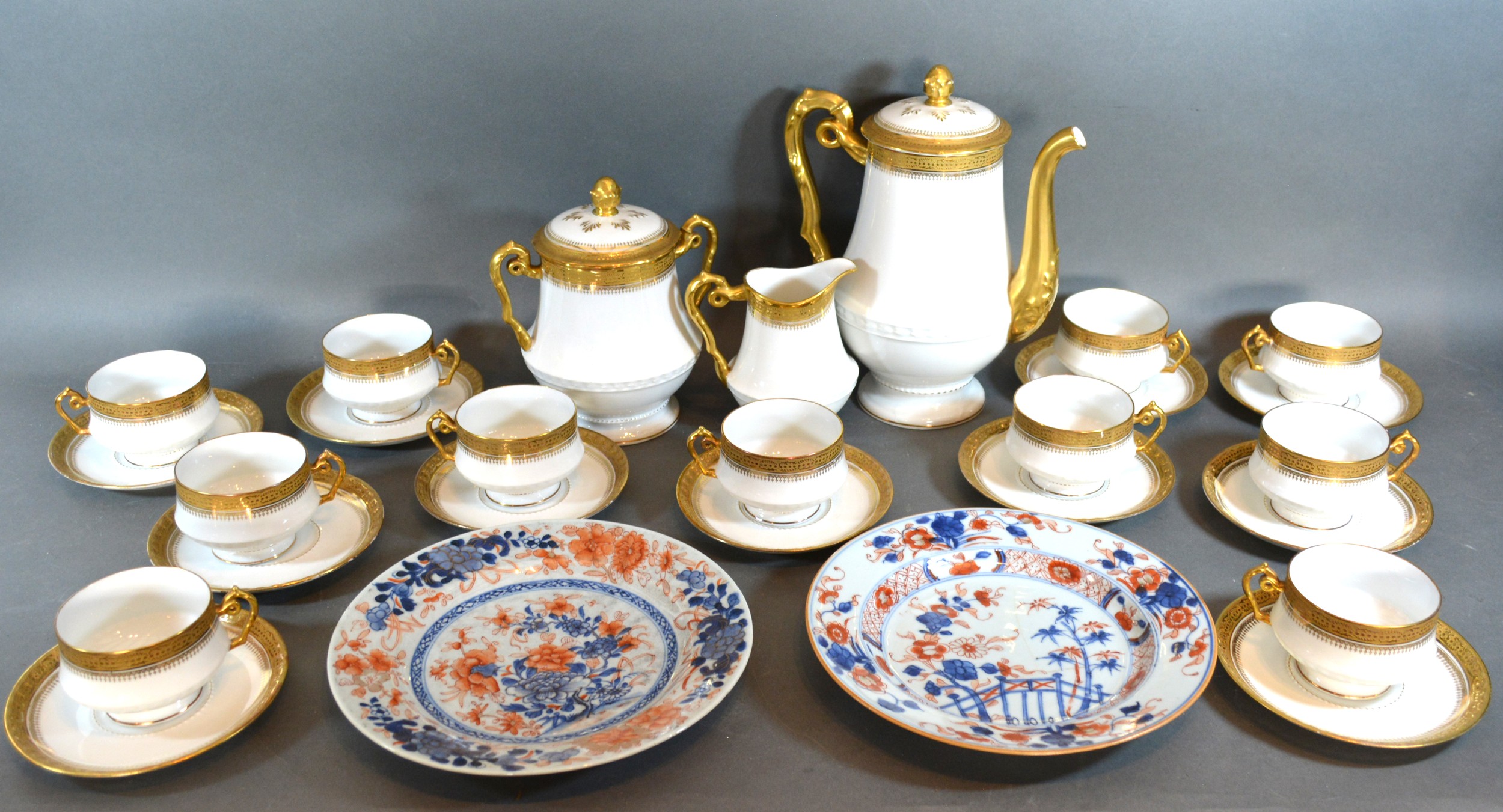 A Limoges Tea Service together with a pair of iron stone plates