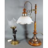 A Patinated metal lamp of figural form with glass shade, together with another table lamp