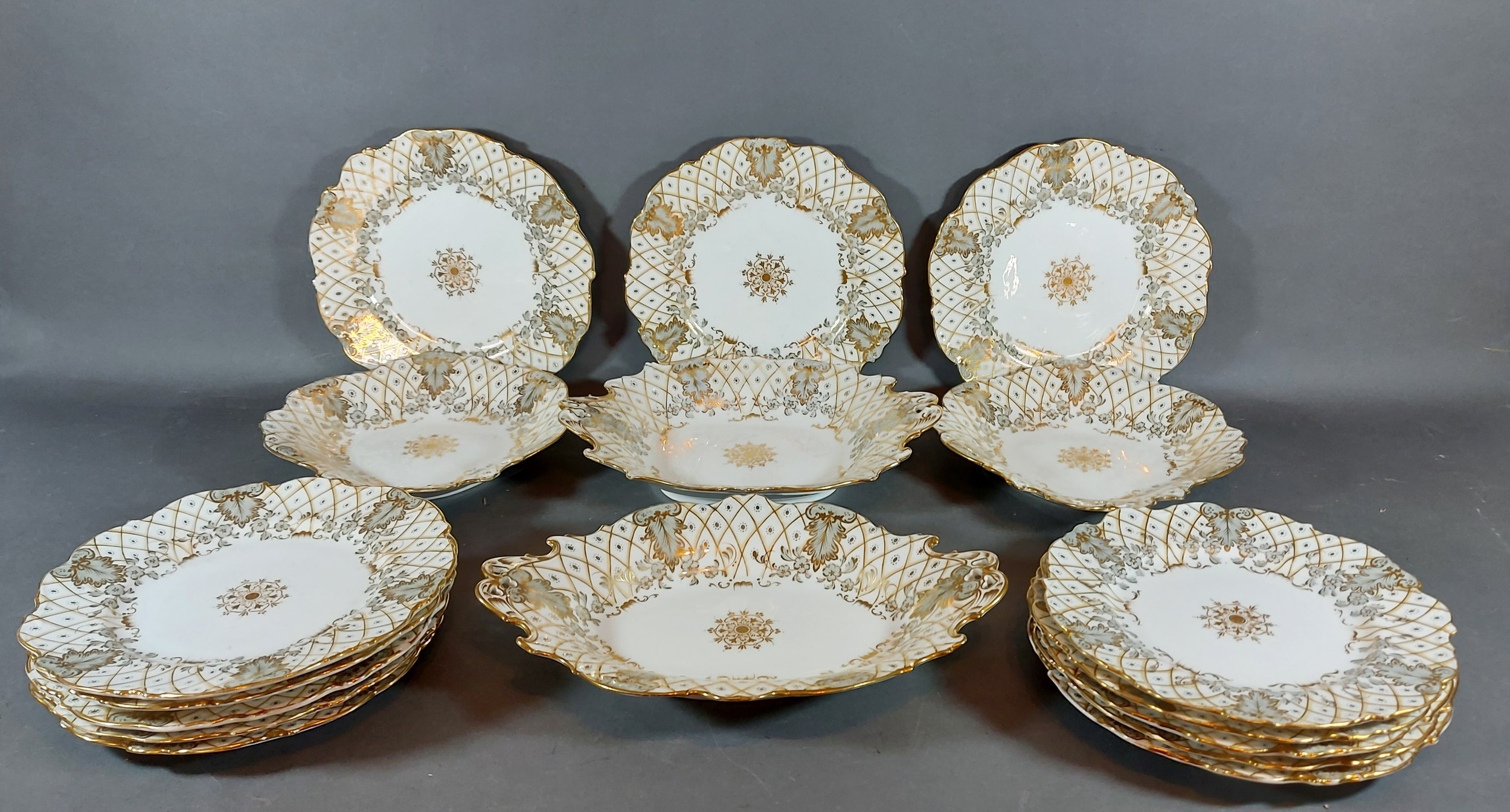 A 19th Century English dessert service comprising thirteen plates and four dishes, all highlighted