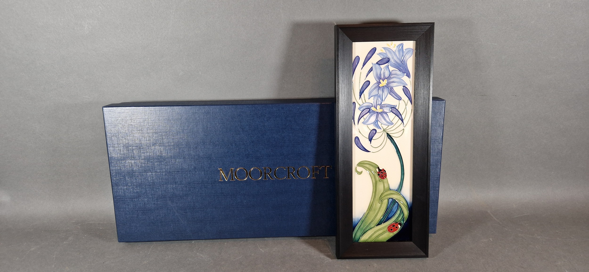 A Moorcroft tube lined rectangular plaque, Fly Away Home pattern, 30.5cms x 9.5cms with original box