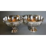 A pair of large punch bowls decorated in relief with grape vine and circular pedestal bases, 39cms