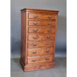 A late Victorian walnut chest, the moulded top above seven drawers raised upon a plinth, 69cms wide,