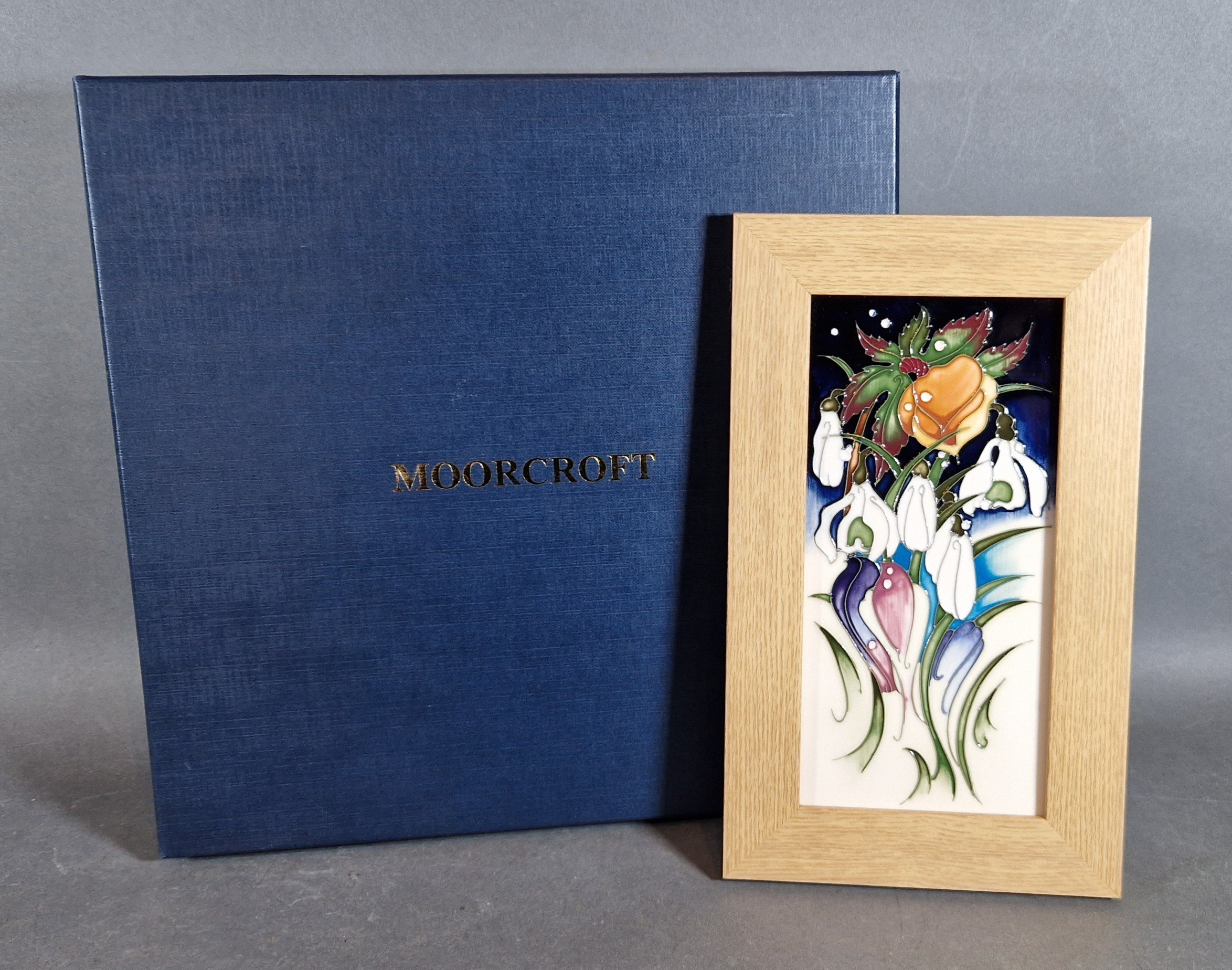 A Moorcroft rectangular plaque, tube lined Snowtime pattern by Emma Bossons, 20.50cms x 10cms with