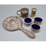 A London silver mustard together with four silver condiments and a silver backed hand mirror