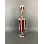 A Bohemian cameo glass vase highlighted with gilt upon ruby glass, 36cms tall