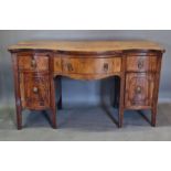 A 19th Century mahogany serpentine sideboard, with three drawers above two cupboard doors raised