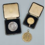 An Astrolabe together with The Kings Trophy Competition medallion and a School Marksman medallion