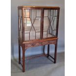 An early 20th century mahogany display cabinet, the two astragal glazed doors enclosing glass