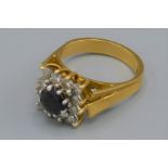 An 18ct gold diamond and Sapphire set ring of square form, 8 grams, ring size P