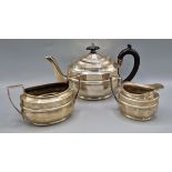 A George V silver three piece tea service comprising teapot, cream jug and sugar bowl, Chester 1938,