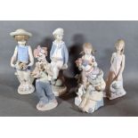 A Lladro porcelain model of a boy with a sailing boat together with five other Lladro porcelain