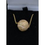 An 18ct gold and diamond and green stone set pendant in the form of a tennis ball together with a