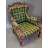 A French mahogany armchair with an upholstered back and seat raised upon cabriole legs with scroll