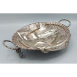 A silver plated Trompe L'oeil bread basket in the form of a two handled basket draped with a