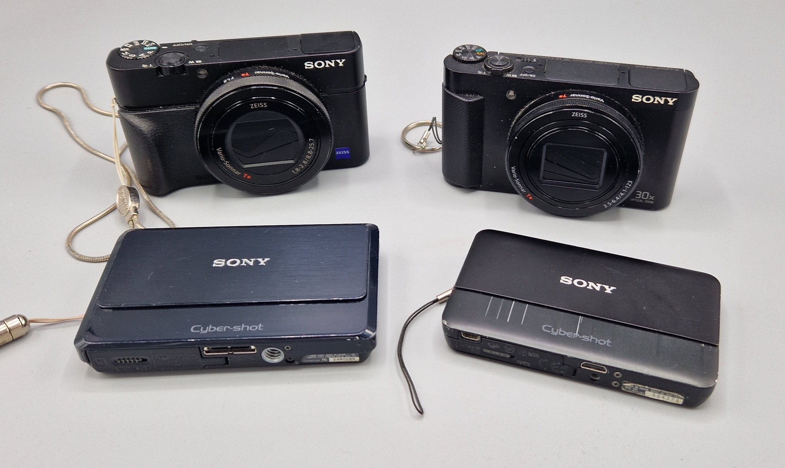 A Sony Exmor RS 4K Cybershot RX100 IV Camera, together with another Sony Cyber shot camera and two